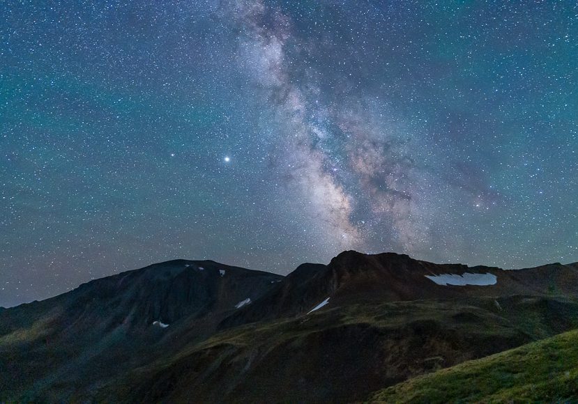 The Milky Way galaxy visible over a mountain range under a clear night sky. The Milky Way galaxy visible over a mountain range under a clear night sky.