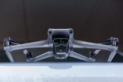 Frontal view of a mavic 3 pro drone on a flat surface ready for takeoff.