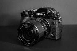 A Fujifilm X-T5 camera with a Fujinon lens is displayed against a plain dark background.