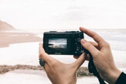 Person Taking Picture of Sea Using Point-and-shoot Camera