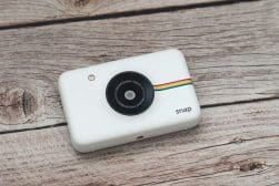 Polaroid snap camera on a wooden background
