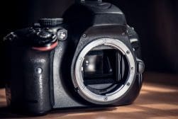 Digital slr camera body without a lens, revealing the mirror and sensor chamber.